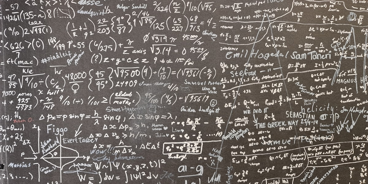 Blackboard densely covered in mathematical derivations